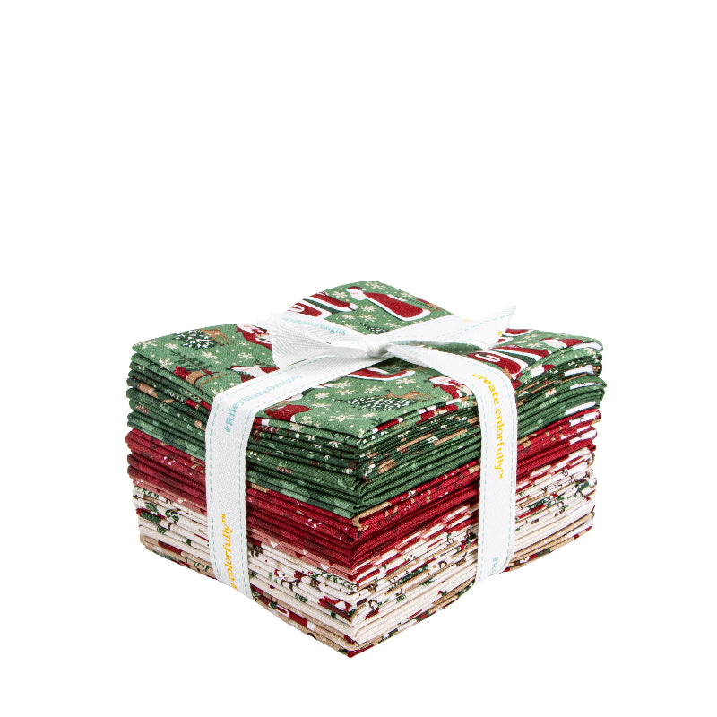 Stack of red, green, and white fabric bundles tied with a white ribbon on a white background