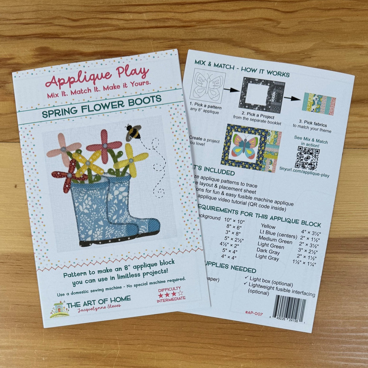 A printed craft pattern sheet titled 'Applique Play: Spring Flower Boots' shown on a wooden surface, alongside the back of the same sheet explaining how to mix, match, and apply the pattern.
