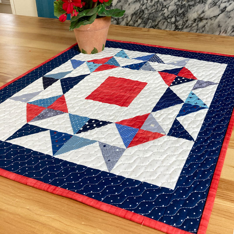 Red white and blue quilt on wooden table