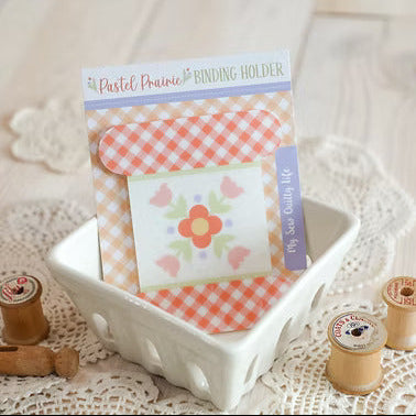 Pastel Prairie Binding Holder with floral design on a lace surface