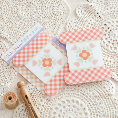 Set of small cards with floral designs on a textured surface