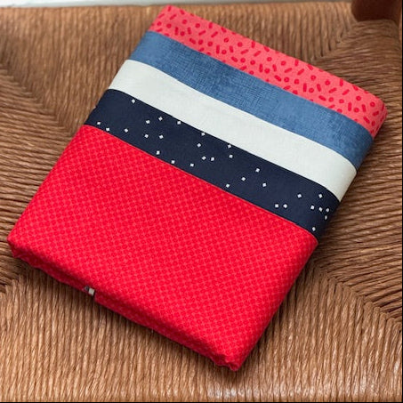 Bundle of red white and blue fabric on wicker.