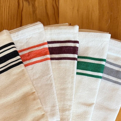 Striped colorful vintage tea towels on wood table