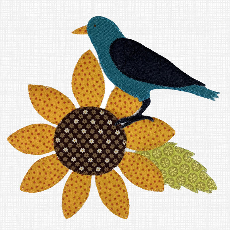 A stylized patchwork applique design of a blue bird perched on a yellow sunflower with a patterned brown center and green leaf, shown on a white textured fabric background.