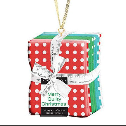 Decorative Christmas ornament with polka dot packaging and a measuring tape, featuring Moda Fabrics branding.