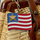 American flag keychain on a woven surface