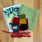 Assorted fabrics and felts on wood table