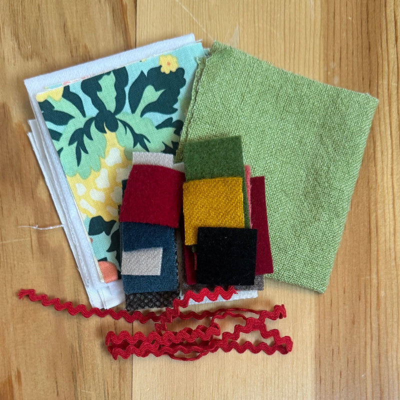 Assorted fabrics and felts on wood table