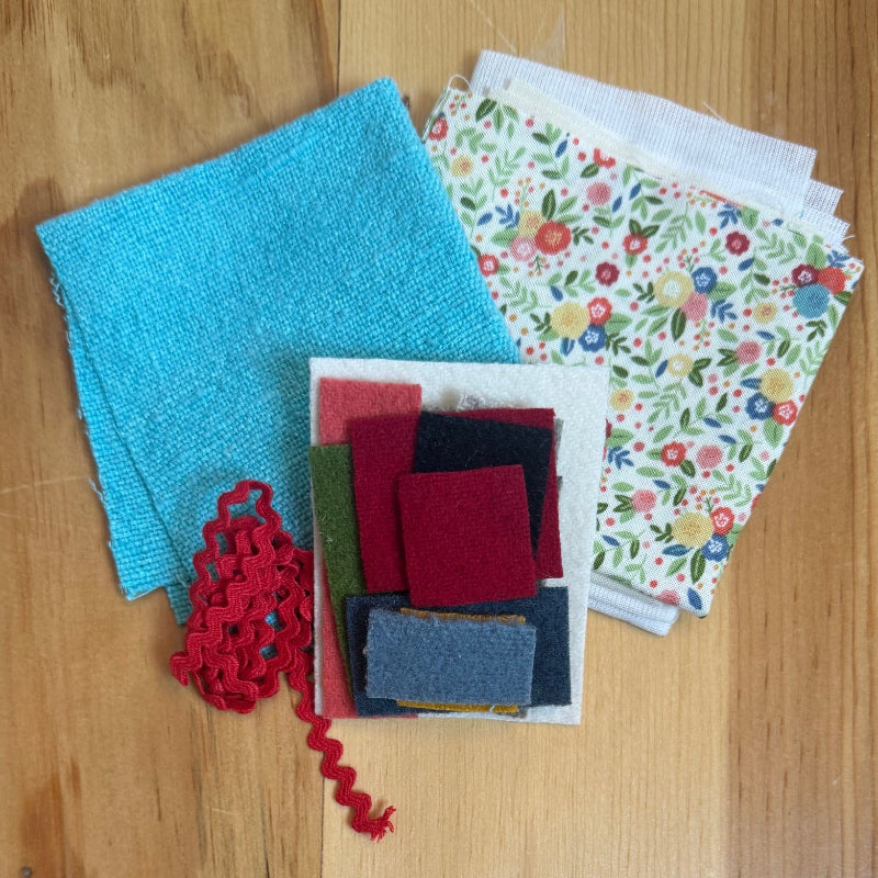 Assorted fabrics and felts on wood table