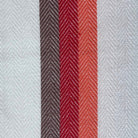 Striped towel with red and gray stripes on a wooden surface