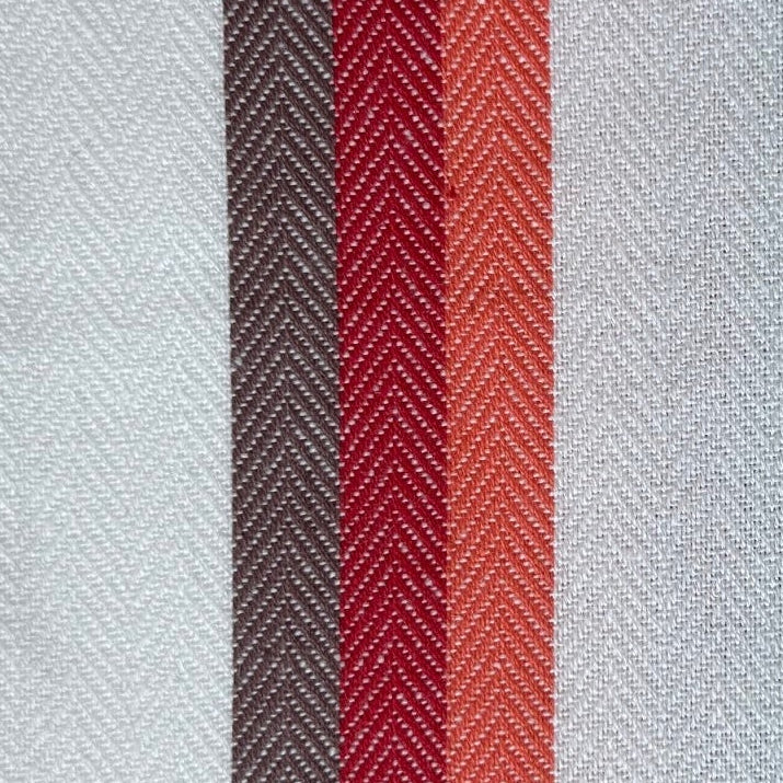 Striped towel with red and gray stripes on a wooden surface