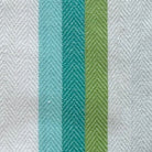White towel with green stripe on a wooden surface