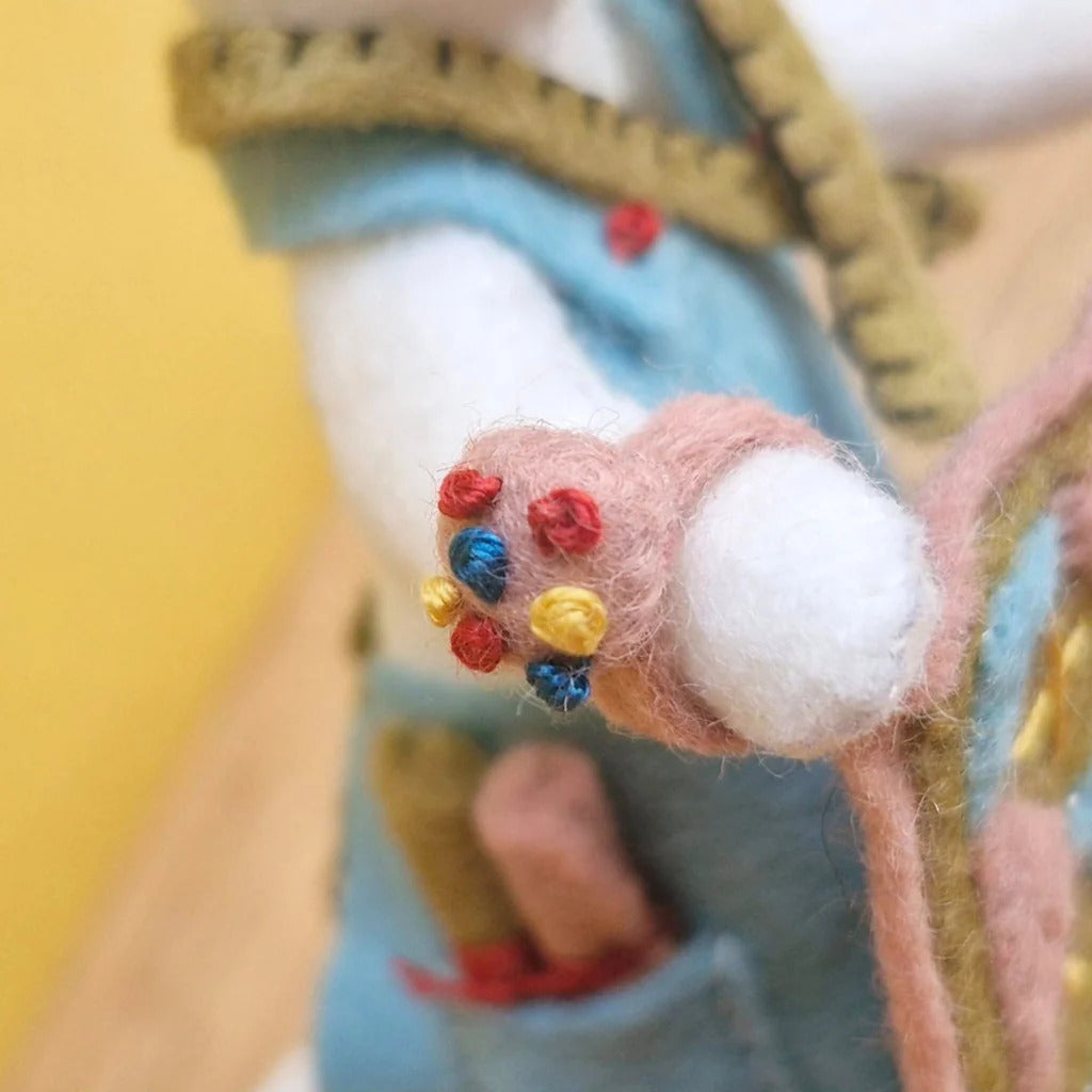 Close-up of a hand with a colorful pin cushion on a blurred background