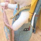 Close-up of a hand holding a quilt with a blurred background