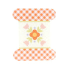 Decorative item with floral design and checkered patterns on a white background