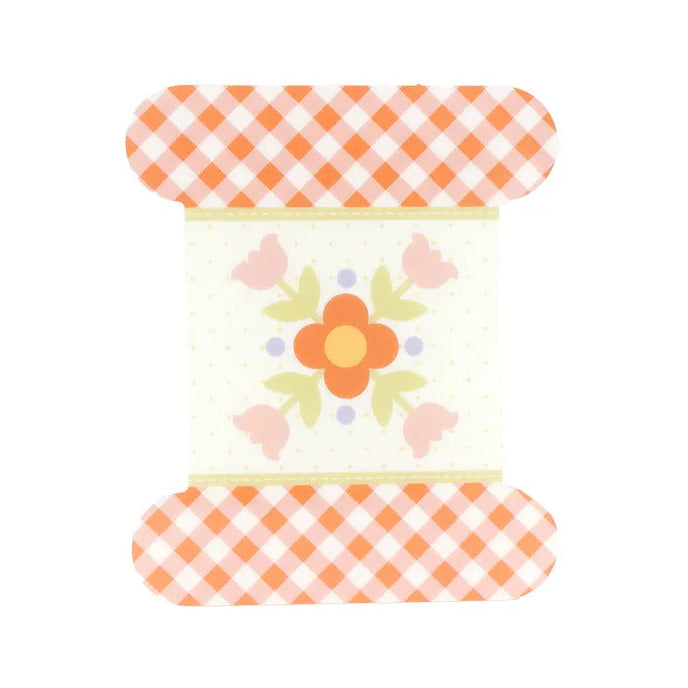 Decorative item with floral design and checkered patterns on a white background