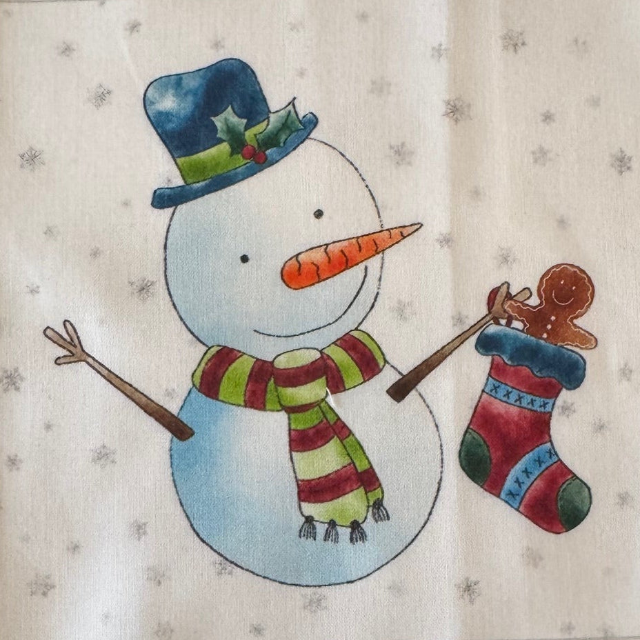 Decorative wall hanging with a cartoon snowman holding a stocking.