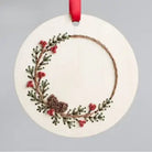 Decorative Christmas ornament with a wreath design on a gray background