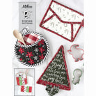 Sewing patterns and fabric pieces with Christmas designs of potholders on a white background