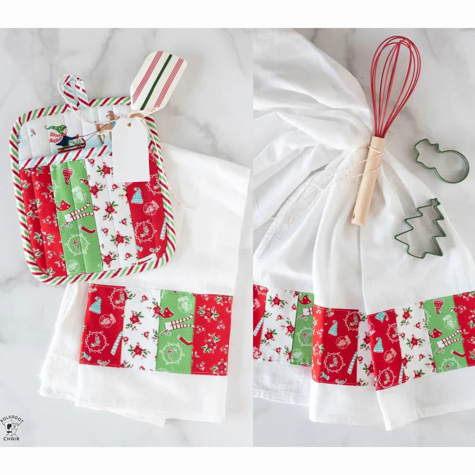Set of Christmas-themed kitchen towels with a whisk and cookie cutters on a white background