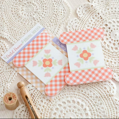 Set of small cards with floral designs on a textured surface