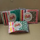 Three packages of fabric with colorful patterns on a beige surface.