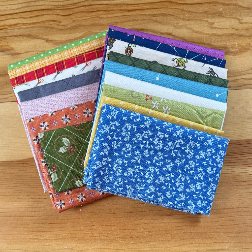 colorful fabric swatches on a wooden table 
