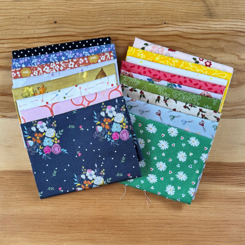 Collection of fabric swatches on a wooden surface.