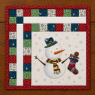 Quilted Christmas-themed panel with a snowman holding a stocking and gingerbread man, framed by a colorful patchwork border.