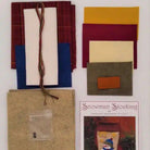 Crafting materials and a pattern book for making a snowman stocking on a white background.