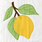 A stylized applique design of a yellow lemon with two green leaves and a brown stem on a white patterned fabric background.