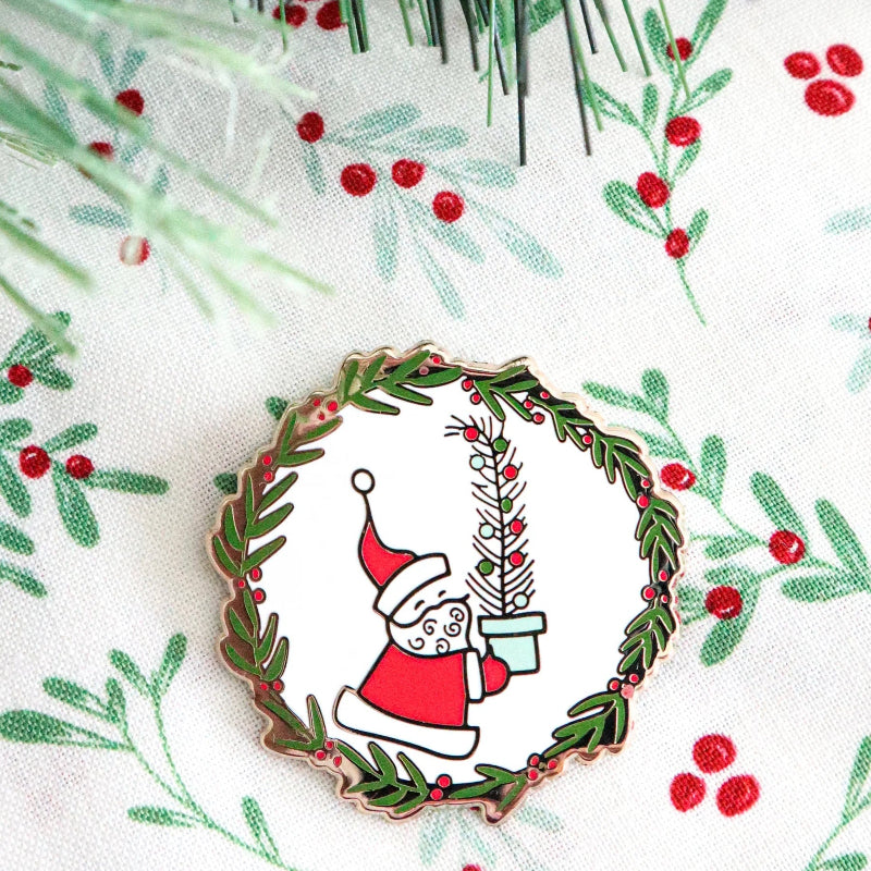 Christmas-themed design with a wreath, Santa Claus, and holly berries on a white background.