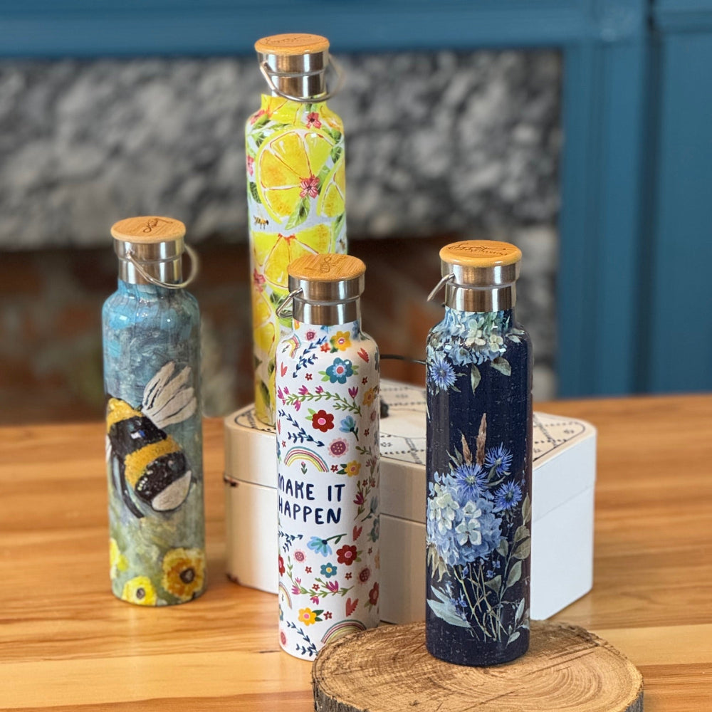 Set of decorative water bottles on a wooden surface with a blurred background