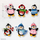 Set of six penguin ornaments with various outfits and accessories on a white background.